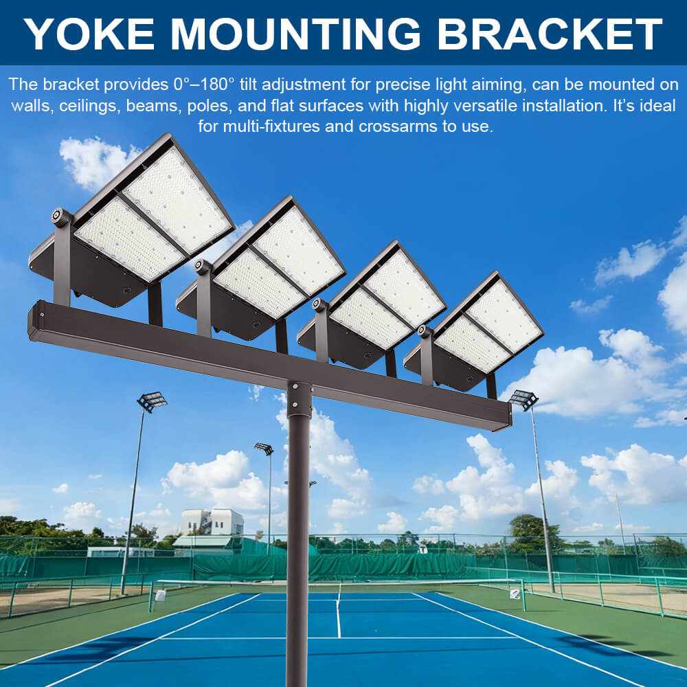 Konlite Spica 600W LED Tennis court light Yoke mounting bracket with four light fixtures on a tennis court against a blue sky.