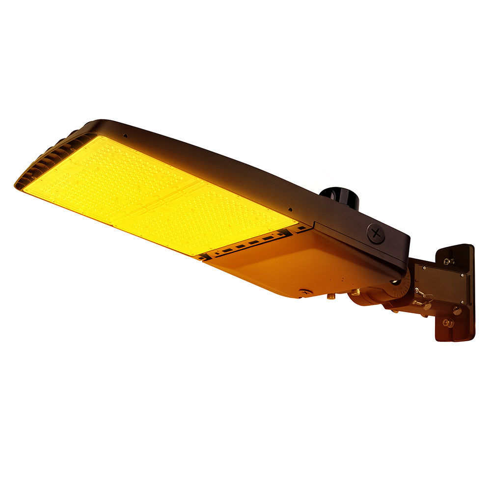 Vela Amber LED Area Light in Dark Bronze with universal mount and photocell.