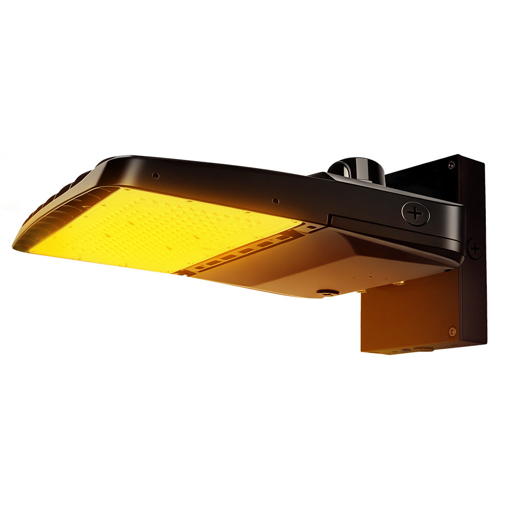 Vela Amber LED Area Light in black with wall mount and photocell