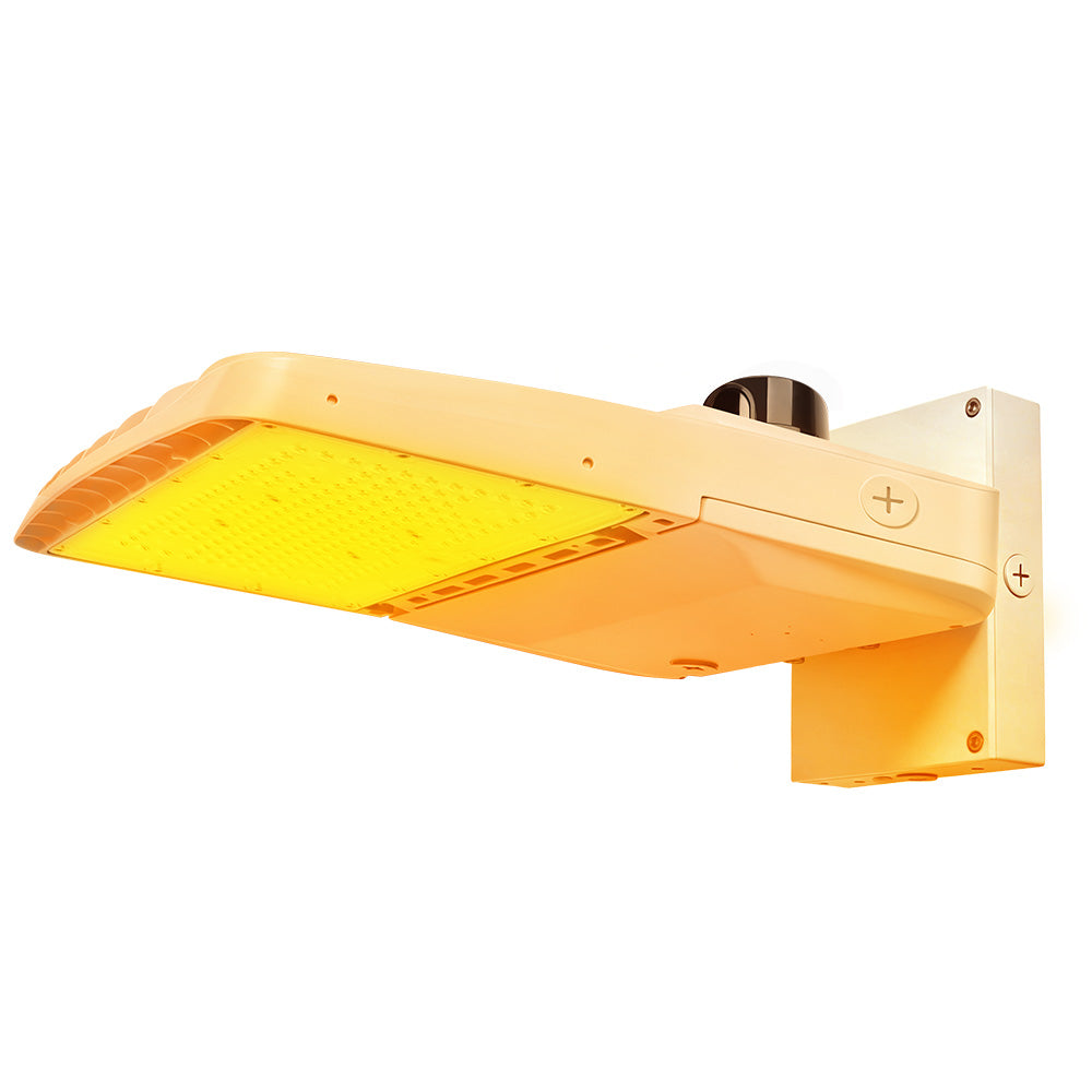 Vela Amber LED Area Light in white with wall mount and photocell