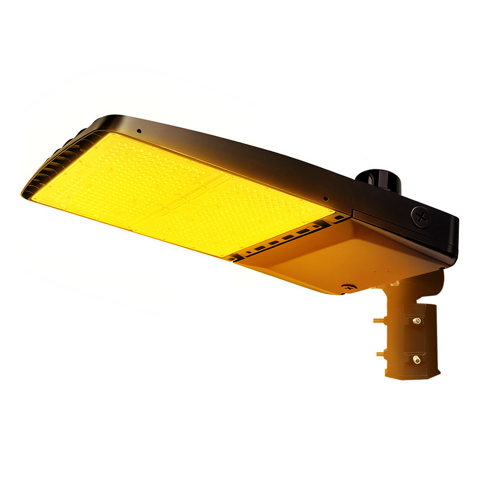 Vela Amber LED Area Light in black with slipfitter and photocell.