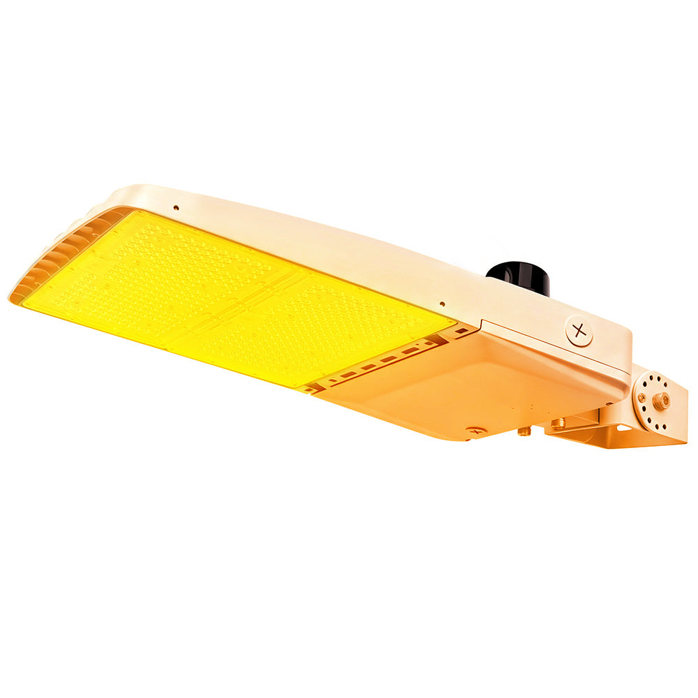 Vela Amber LED Area Light in white with yoke mount and photocell.