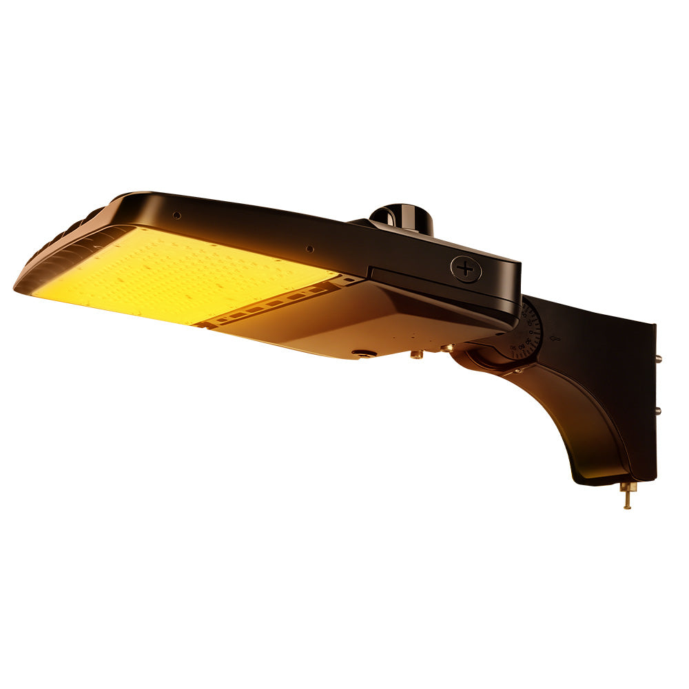 Vela Amber LED Area Light in black with extrusion arm and photocell