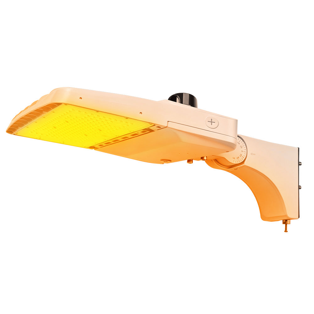 Vela Amber LED Area Light in white with extrusion arm and photocell