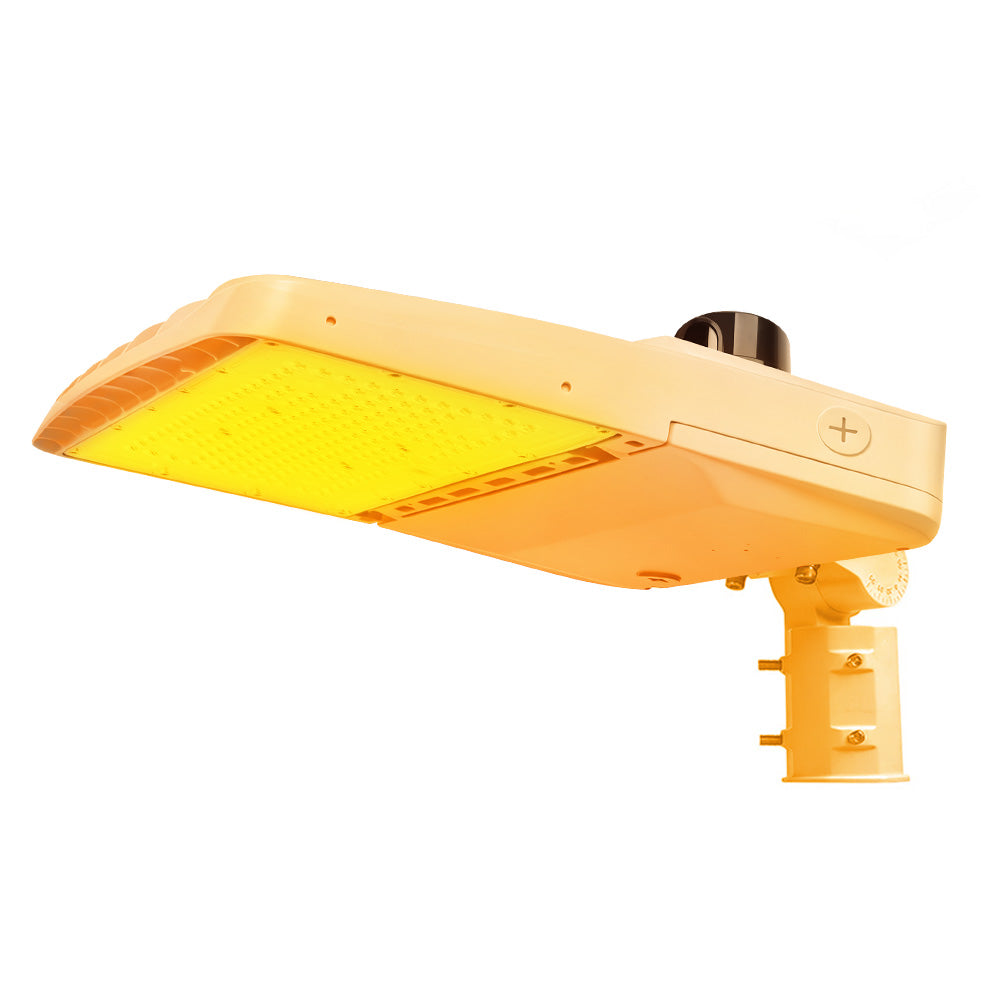 Vela Amber LED Area Light in white with slipfitter and photocell