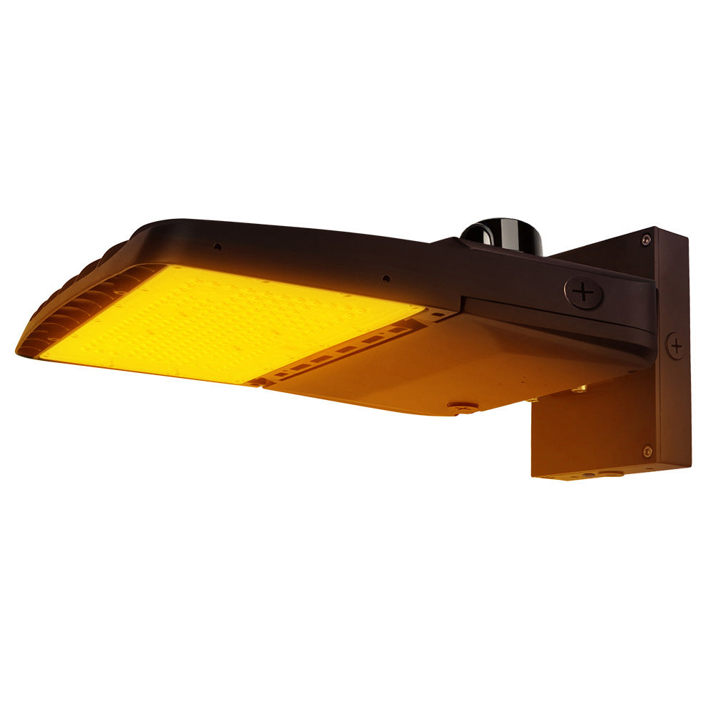Vela Amber LED Area Light in Dark Bronze with wall mount and photocell
