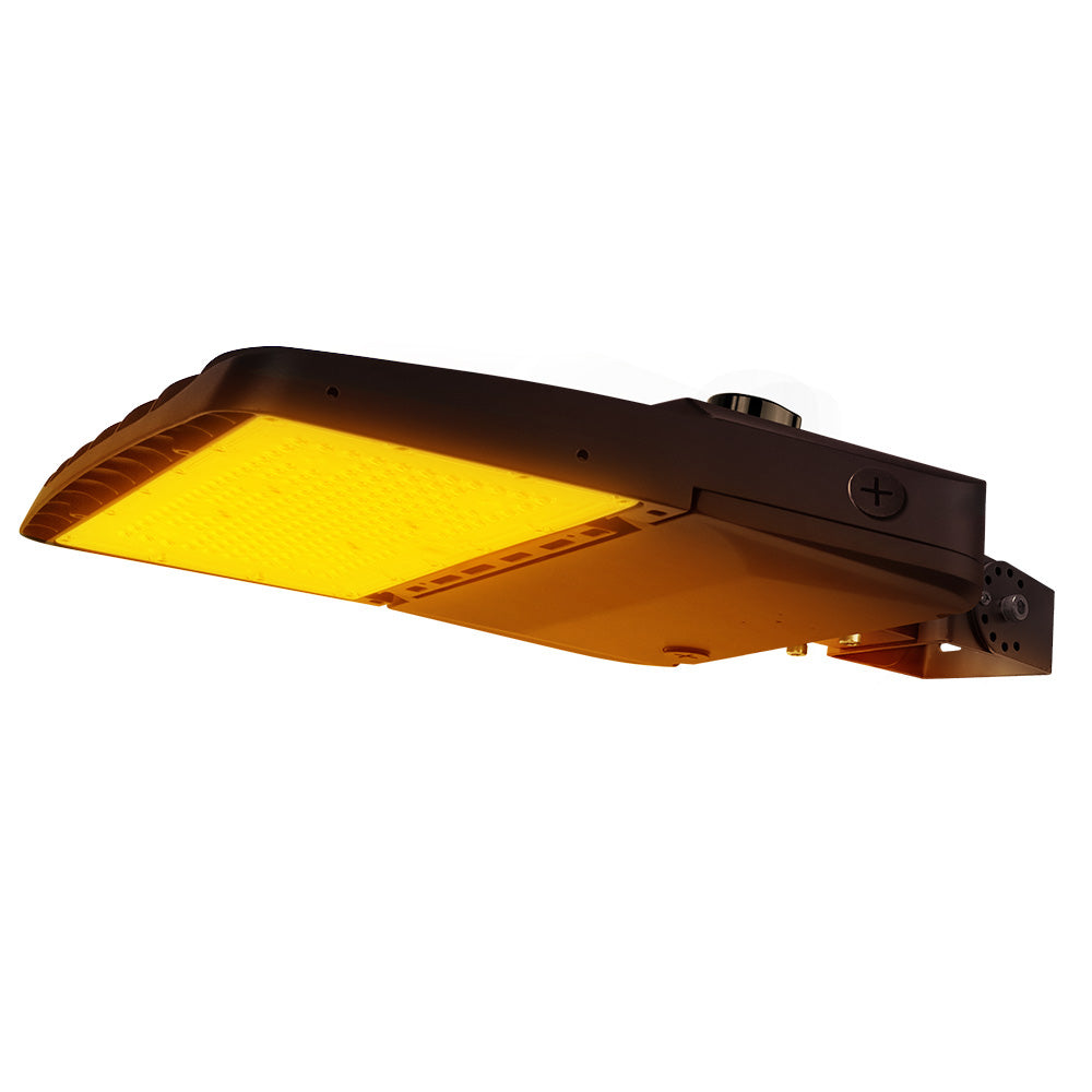 Vela Amber LED Area Light in Dark Bronze with yoke mount and Shorting Cap.