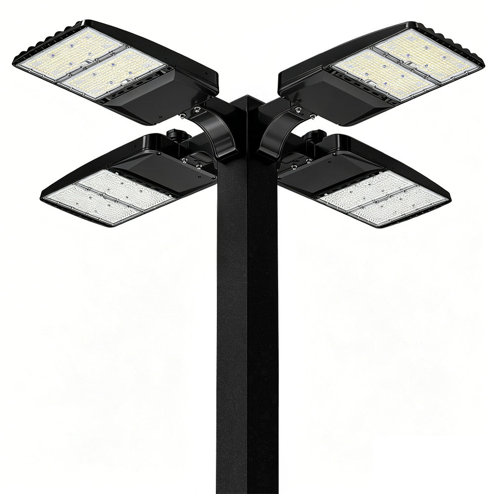 Black outdoor floodlight with four LED lights on a white background