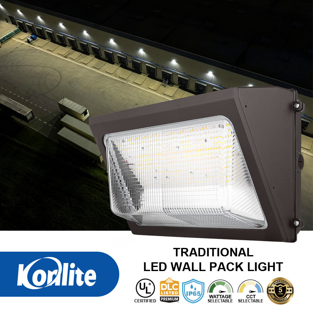 Korlite traditional LED wall pack light shown in front of a house at dusk, with product text and certification badges below.